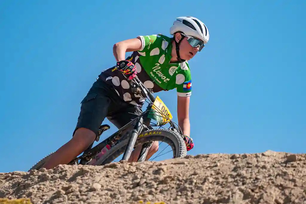 Niwot High School Mountain Bike rider dropping into the switchbacks at Eagle