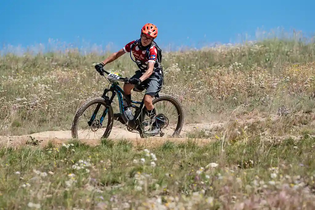 A St. Vrain High School Mountain Bike team member prepares to negotiate a corner at Frisco