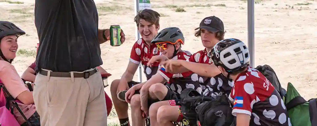 The St. Vrain High School Mountain Bike Team members interact and joke it up at a team event in the tent