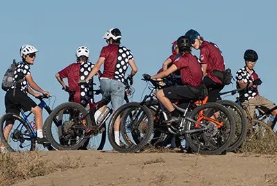 Riders of the Silver Creek MTB team engage in conversation during practice